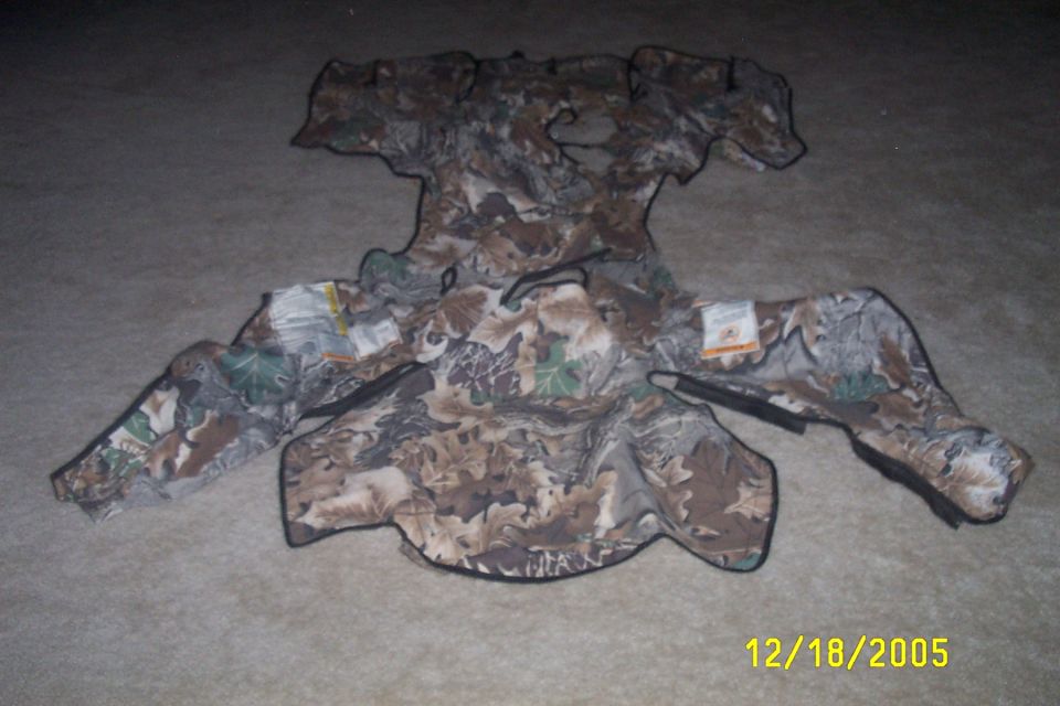 Camouflage hunting garment with tags laid flat on carpet
