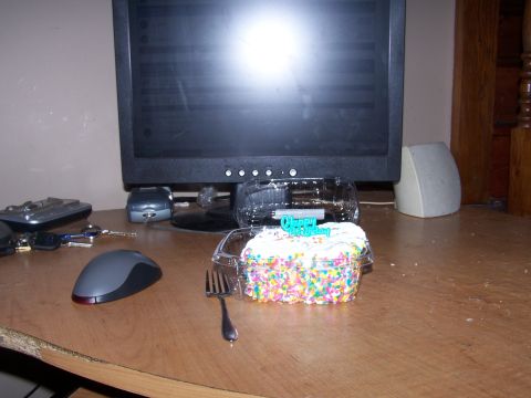 1979 Ford F-150 - A desk scene a computer monitor, mouse, keys, and a decorated cupcake with a 'Happy Birthday' topper.