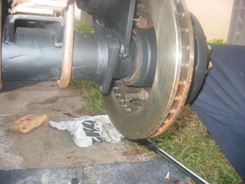 1989 Ford Bronco - Close-up view of a vehicle's axle and brake rotor assembly, with a wrench in place.