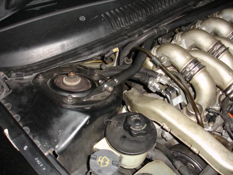 1993 Ford Taurus - Close-up view of an engine bay, focusing on the intake manifold and a power steering fluid cap.