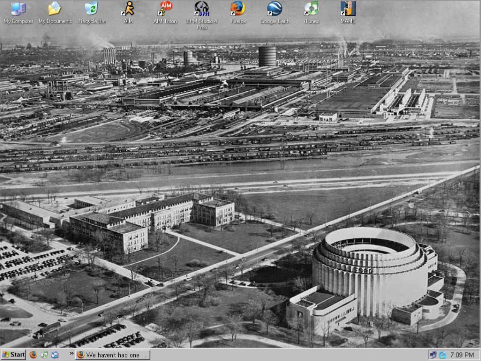 Windows XP desktop screenshot with vintage aerial photo of an industrial plant as wallpaper