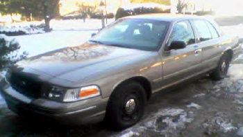 2000 Ford Crown Victoria - Tan 2000 Ford Crown Victoria parked outside in winter conditions.