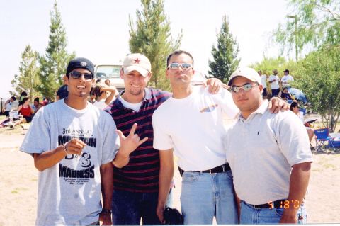 1995 Ford Bronco - A group of four men pose in front of a light-colored truck, possibly a 1995 Ford Bronco, at an outdoor event.