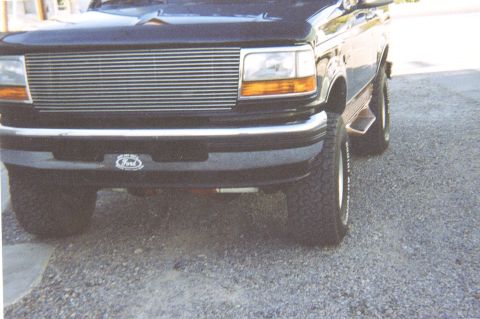 1995 Ford Bronco - Front view of a 1995 Ford Bronco with a chrome grille and Ford emblem.