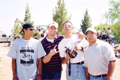 1995 Ford Bronco - A group of friends gather for a photo at an outdoor event, with several vehicles visible in the background.