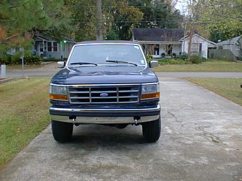 1992 Ford Bronco - Front view of a 1992 Ford Bronco parked on a concrete driveway.