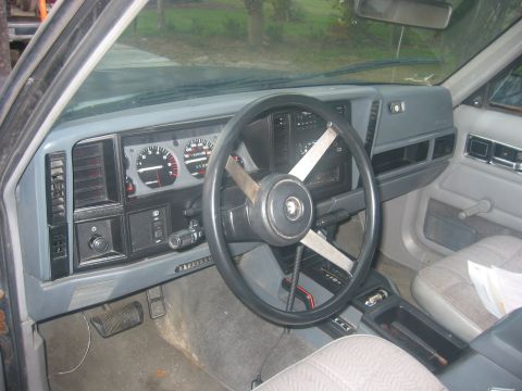 1989 Ford Bronco - Interior view of a Jeep Cherokee XJ, showing the dashboard, steering wheel, and front seats.