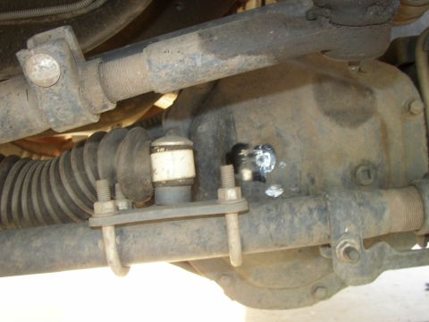 2001 Ford Excursion - Close-up view of the front axle and steering assembly, showing various mechanical parts.
