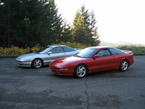 1994 Ford Probe - Two Ford Probes, a red one in the foreground and a silver one behind it, are parked outdoors.