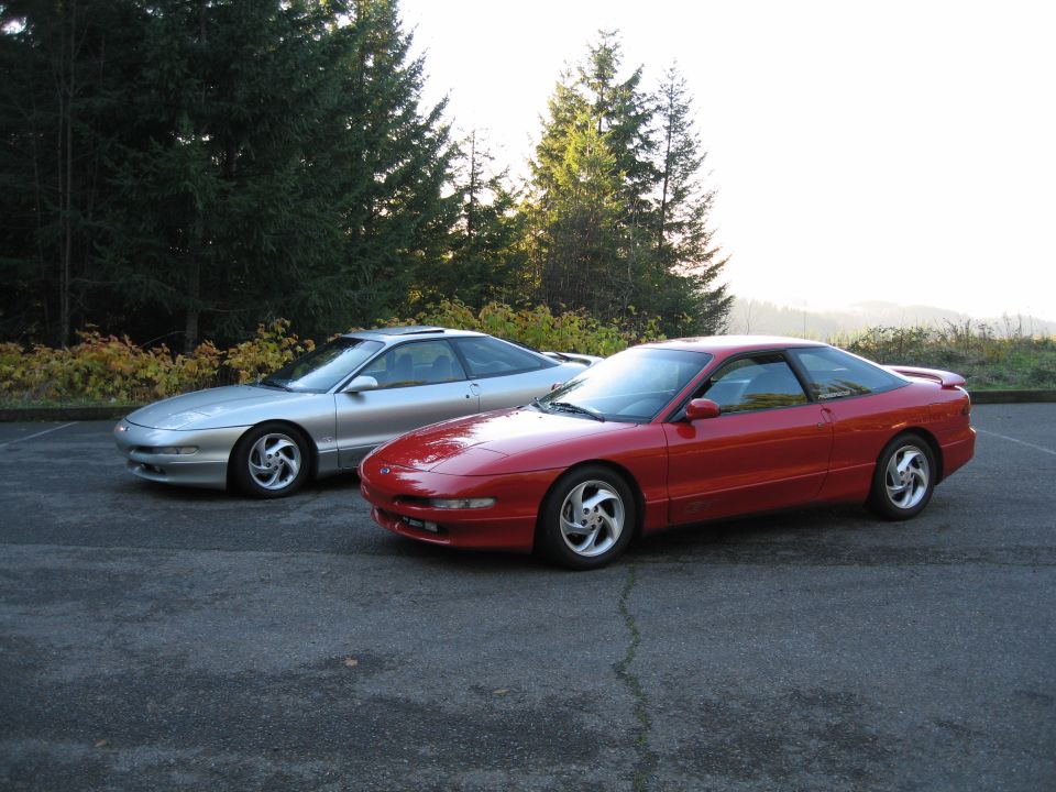 Red and silver 1994 Ford Probes parked side-by-side