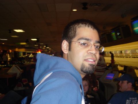 1995 Ford Probe - A man wearing a blue hoodie and glasses poses for a photo at a bowling alley.