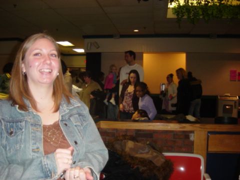 1995 Ford Probe - A group of people are gathered indoors, with a woman in the foreground smiling at the camera.