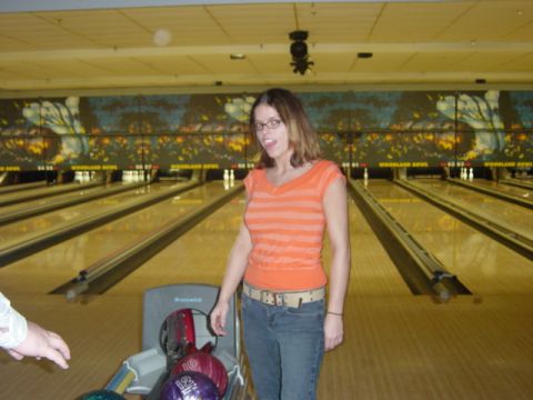 1995 Ford Probe - A woman poses for a photo at a bowling alley with bowling balls in the foreground.