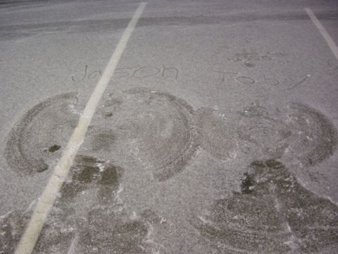 1995 Ford Probe - Names written in the snow next to snow angels on a paved surface.