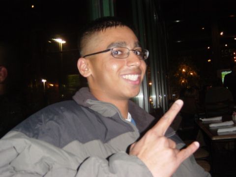 1995 Ford Probe - A man smiles while making a hand gesture at a party.