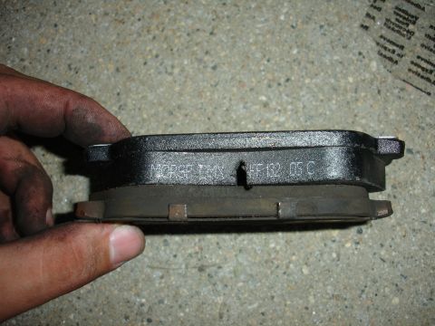 1995 Ford Taurus - A close-up shows a brake pad with part numbers visible, held by a hand.