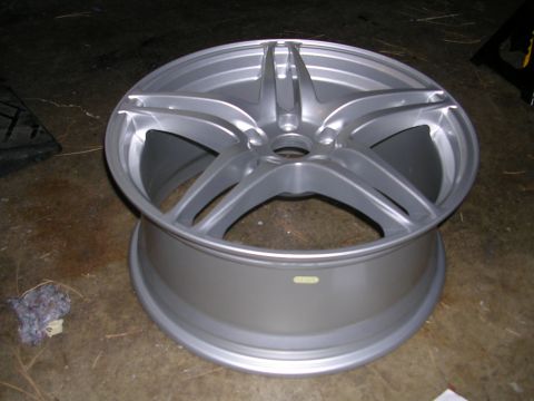 1996 Ford Probe - A single silver alloy wheel is shown, with a small yellow sticker visible on its side.