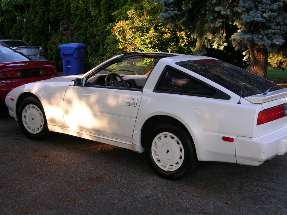 White Nissan 300ZX Z31 coupe rear three-quarter on driveway with white turbine wheels
