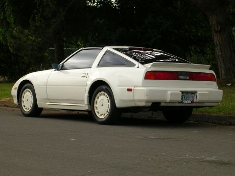 1989 Nissan 300ZX - This 1989 Nissan 300ZX is parked on a street with trees in the background.