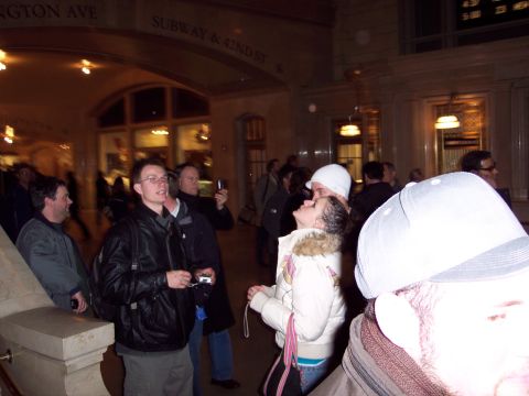 2001 Ford Crown Victoria - Interior view of Grand Central Terminal with people and signage visible.