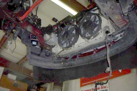 1997 Ford Taurus - The engine bay of a vehicle is shown from below, cooling fans and exposed mechanical components.