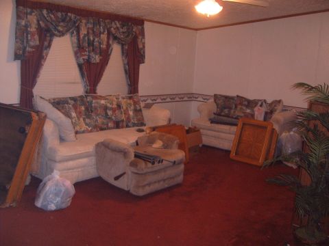 1988 Ford Bronco - Interior scene of a room furnished with a sofa, armchair, and decorative curtains.