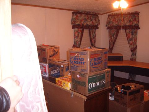 1988 Ford Bronco - A collection of beverage boxes is visible in a room, obscuring any potential vehicle.