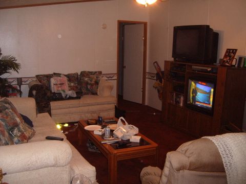 1988 Ford Bronco - Interior view of a living room sofas, a coffee table, and entertainment consoles with televisions.