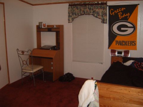 1988 Ford Bronco - Bedroom scene a desk, chair, bed, and a Green Bay Packers banner on the wall.