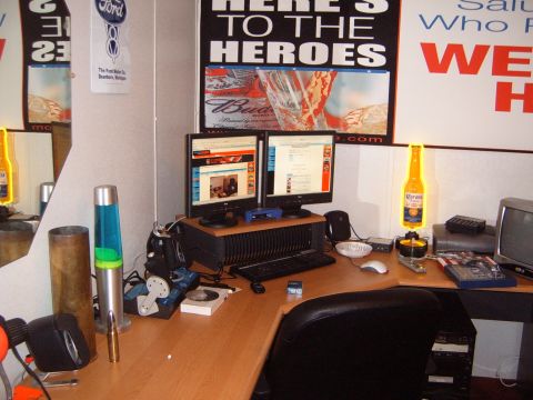 1988 Ford Bronco - A cluttered desk area features computers, a lava lamp, and various posters, including one for Ford.