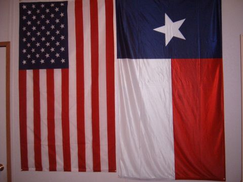 1988 Ford Bronco - American and Texas flags displayed together on a wall, with a Supermotors.net watermark.
