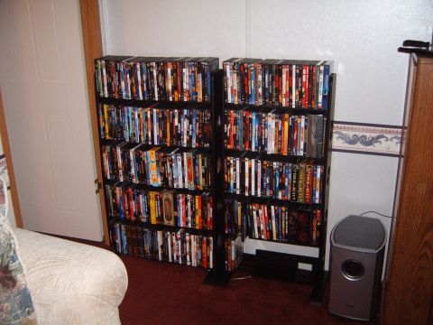 1988 Ford Bronco - A collection of DVDs is neatly organized on two shelves in a room.