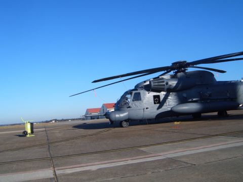 1988 Ford Bronco - A large gray helicopter sits on an airport tarmac under a clear blue sky.