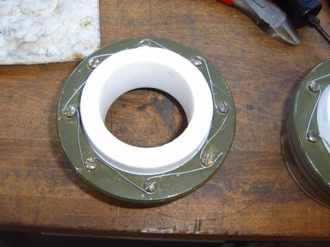 1988 Ford Bronco - A close-up view of a mechanical part, possibly a bearing or seal, with a green housing, white inner cylinder, and tension springs.