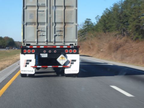 1988 Ford Bronco - Semi-trailer truck with Fontaine mud flaps driving on the highway.