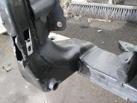 1991 Ford Taurus - Close-up of a damaged car frame section, showing structural components and repair areas.