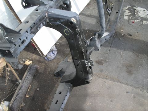 1991 Ford Taurus - Close-up of a vehicle's frame and suspension components, likely undergoing repair or restoration.