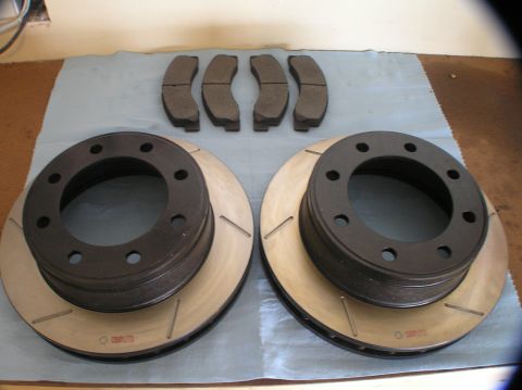 2000 Ford Excursion - A set of new brake rotors and pads are ready for installation.