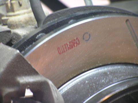 2000 Ford Excursion - Close-up of a brake rotor showing a red stamp and a circular mark.