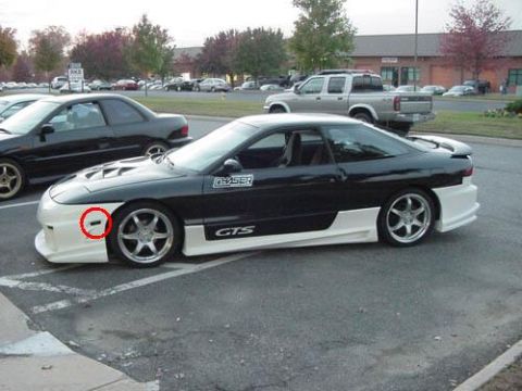 1994 Ford Probe - This 1994 Ford Probe GTS features a two-tone paint scheme and a custom body kit, viewed from the side.