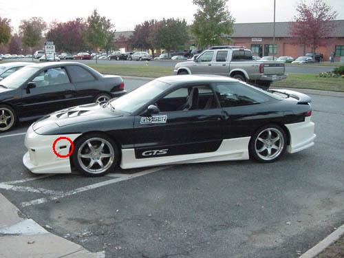 1994 Ford Probe GTS side view with custom white body kit and aftermarket wheels