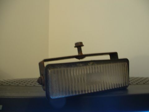1993 Ford Probe - A single car fog light with a ribbed lens and mounting bracket is shown against a plain background.