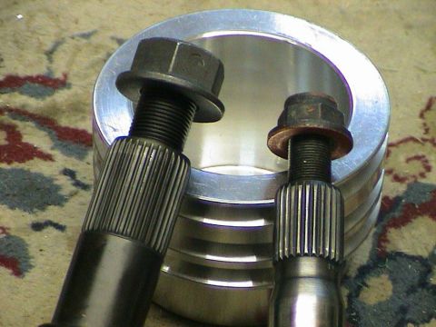 1979 Ford Bronco - Close-up of two axle shafts and a differential housing, likely for a vehicle upgrade.