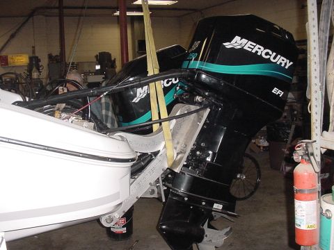 1969 Ford Bronco - Two Mercury outboard motors are being worked on inside a garage or workshop.