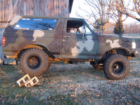 1988 Ford Bronco - This 1988 Ford Bronco features a distinctive camouflage paint scheme and an elevated suspension system.