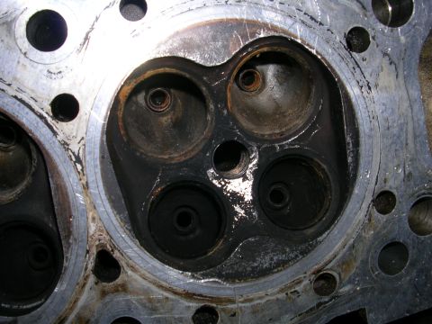 1996 Ford Probe - Close-up view of a used engine cylinder head with visible wear and tear.