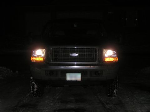 2000 Ford Excursion - A 2000 Ford Excursion is shown from the front at night, its headlights and amber corner lights on.