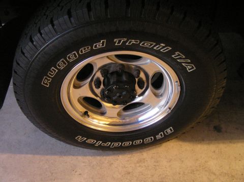 2000 Ford Excursion - A close-up view of a vehicle's wheel and tire, showing the tread and rim details.