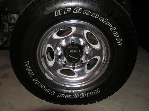 2000 Ford Excursion - A close-up view of a chrome wheel and BFGoodrich tire, showing the tread pattern and brand markings.