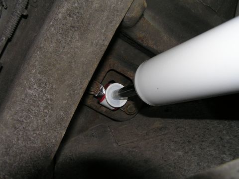 2000 Ford Excursion - A new shock absorber is installed on the undercarriage of a vehicle.